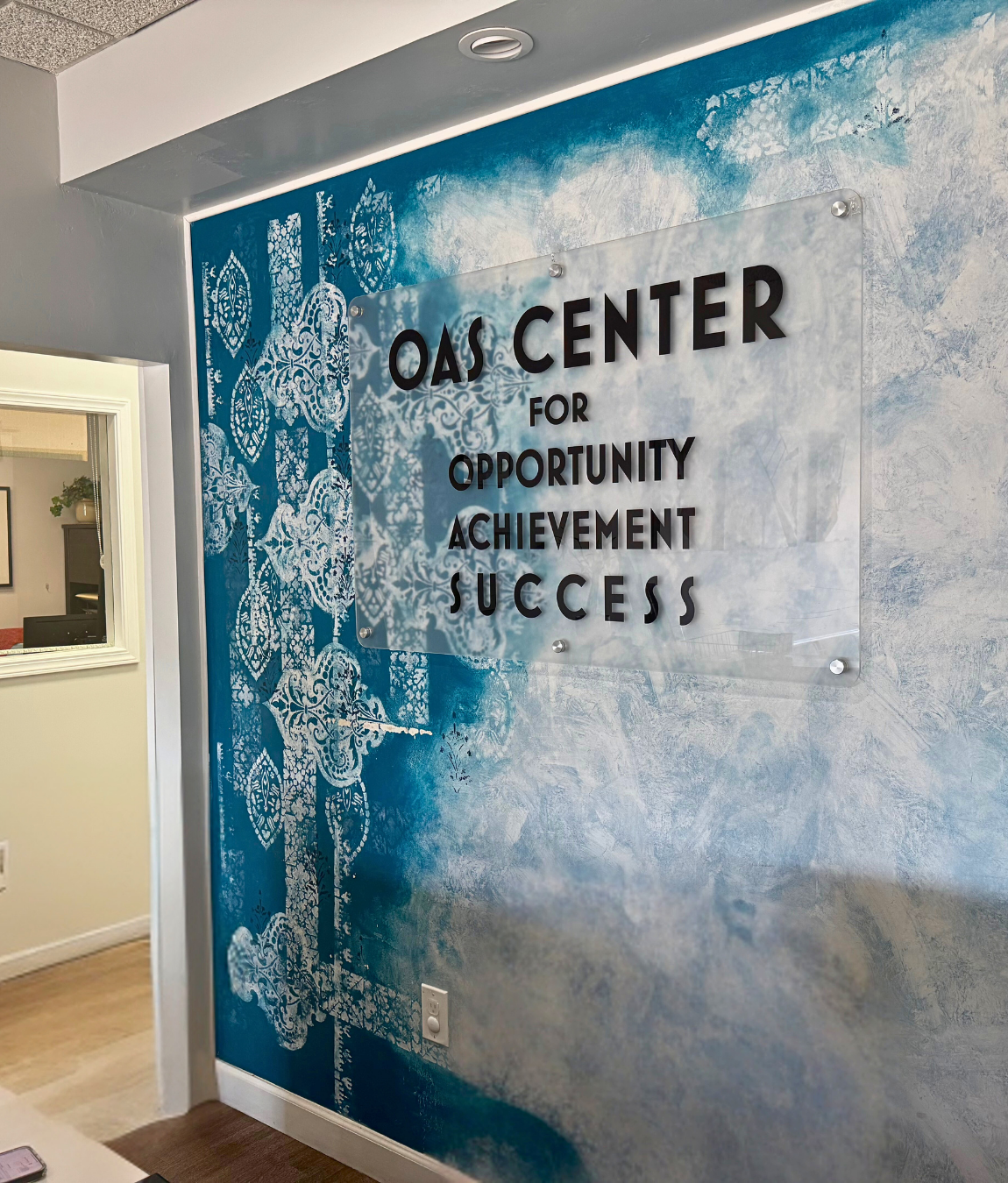 The OAS Center San Diego clinic entrance showing Opportunity Achievement Success wall sign